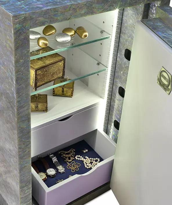 a vault mother of pearl cabinet with jewelry and a drawer