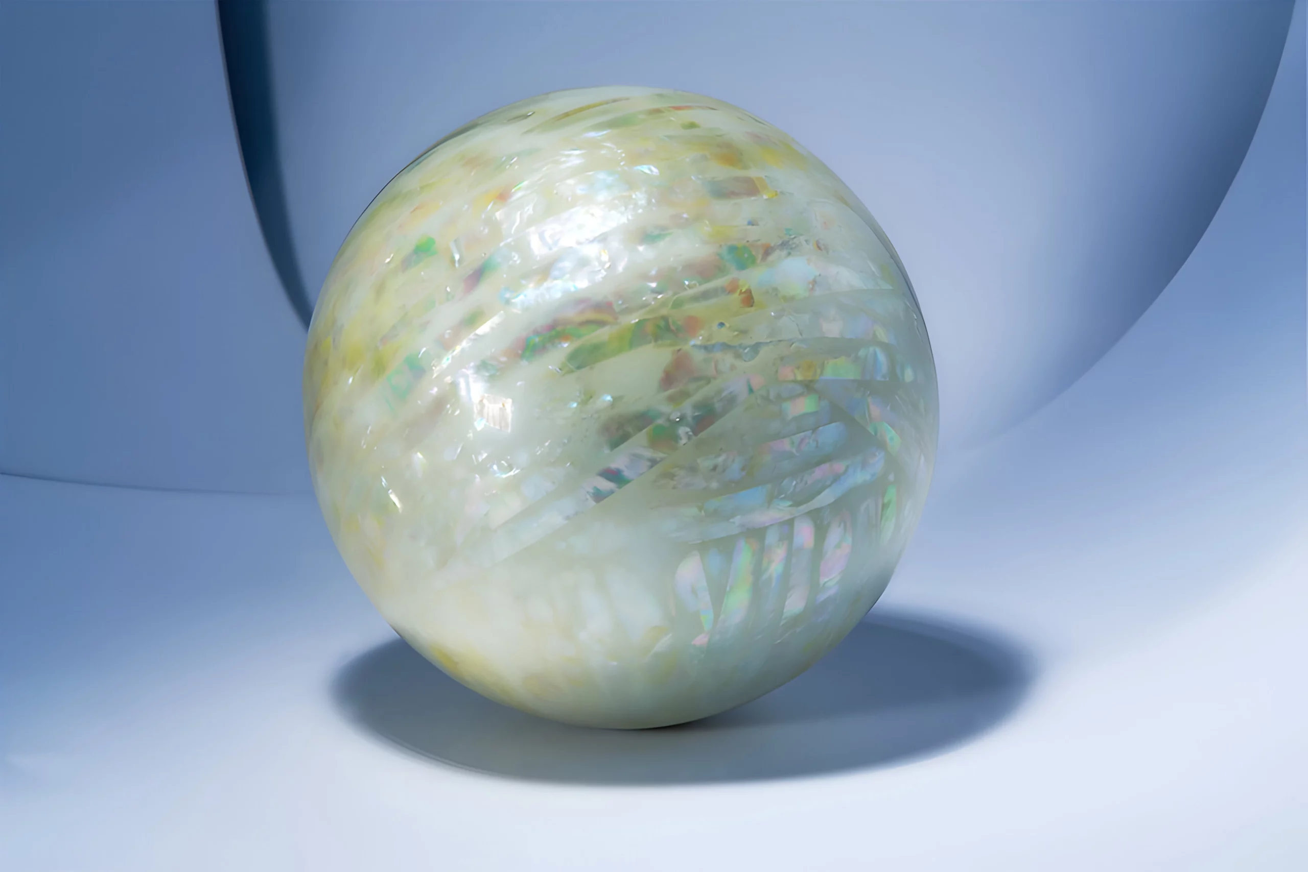 a white round object with iridescent mother of pearls patterns