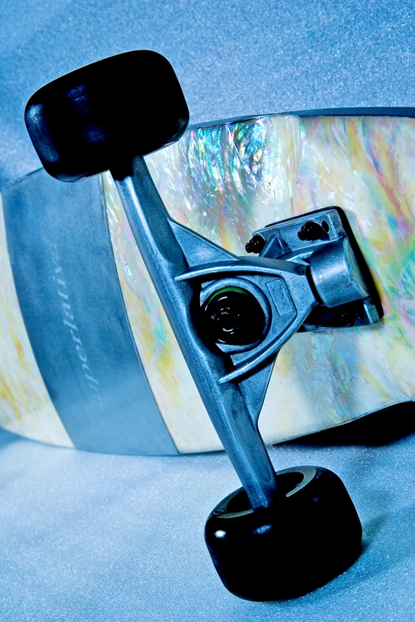 a close up of a mother of pearl custom skateboard