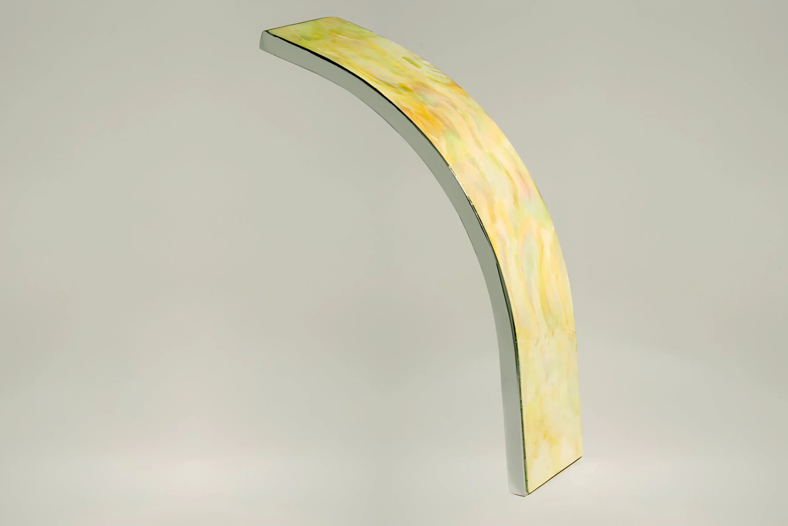 a yellow and white curved object