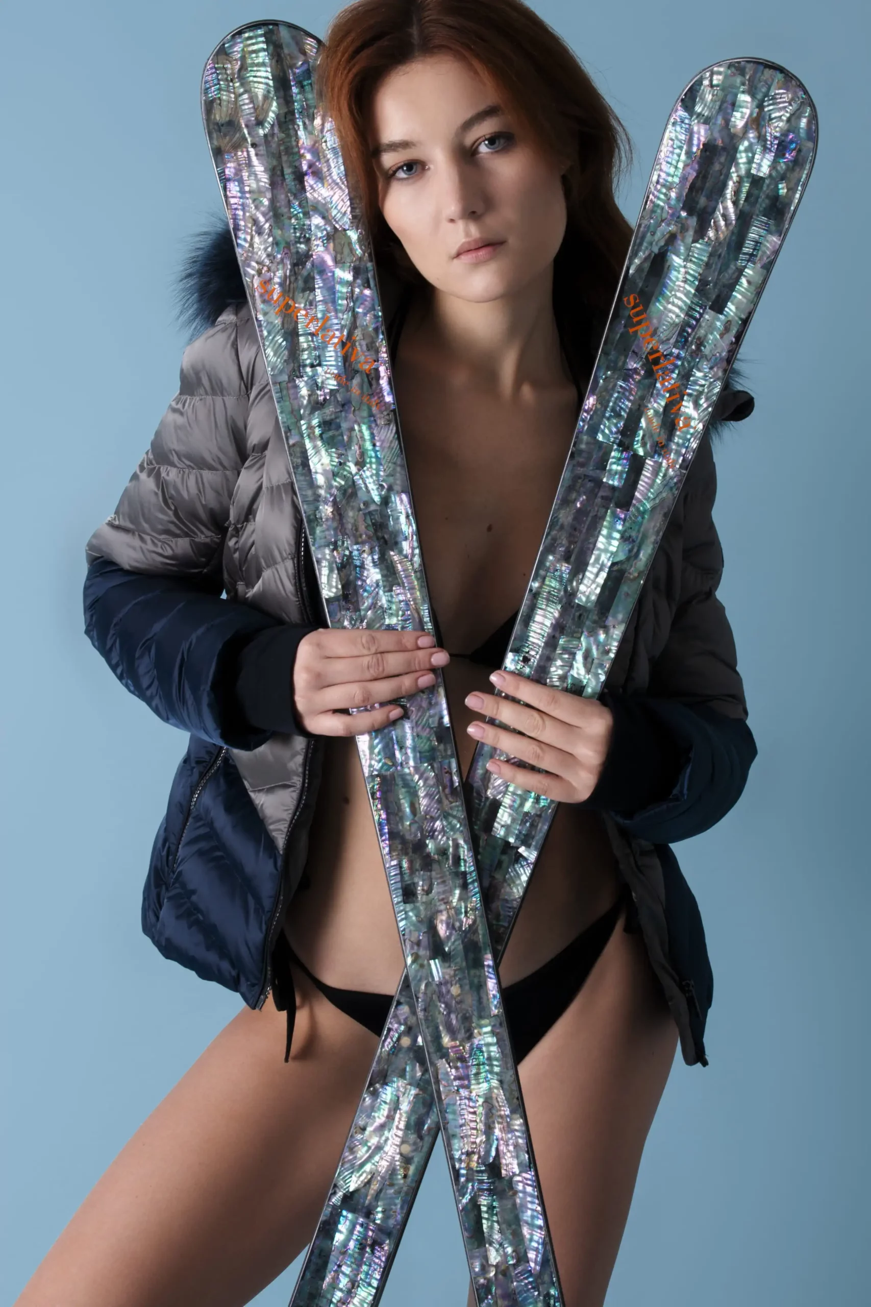a model holding a pair of skis